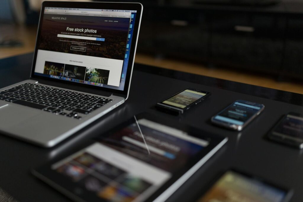 A contemporary workspace showcasing a laptop, tablet, and smartphones, ideal for tech and freelance use.